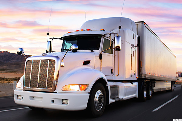 Truck and highway at sunset - transportation background
